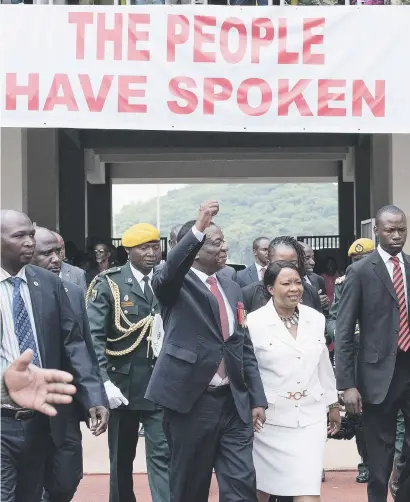  ?? Picture: AFP ?? ‘I AM HERE’. President-elect Emmerson Mnangagwa gestures as he arrives with his wife Auxilia at the National Sport Stadium in Harare yesterday for his inaugurati­on.