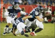  ?? JAMES KENNEY — THE ASSOCIATED PRESS ?? Tennessee Titans wide receiver Nick Williams (14) loses his helmet as he tries to bring down Tampa Bay Buccaneers running back Shaun Wilson, right, in the second half of a preseason NFL football game Saturday in Nashville, Tenn.