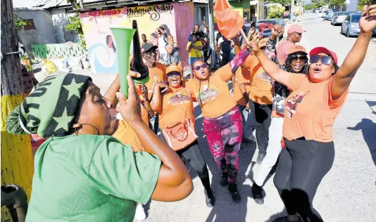  ?? PHOTO BY RUDOLPH BROWN ?? JLP and PNP supporters celebrate on nomination day on February 8.