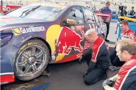  ?? Picture / Mark Horsburgh ?? Red Bull Holden pit crew inspect the damage after Shane van Gisbergen hit a wall at Bathurst yesterday.