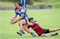  ?? PHOTO: RICKY WILSON/STUFF ?? Central player Trance Poa tries to shrug clear of a Nelson College tackler.