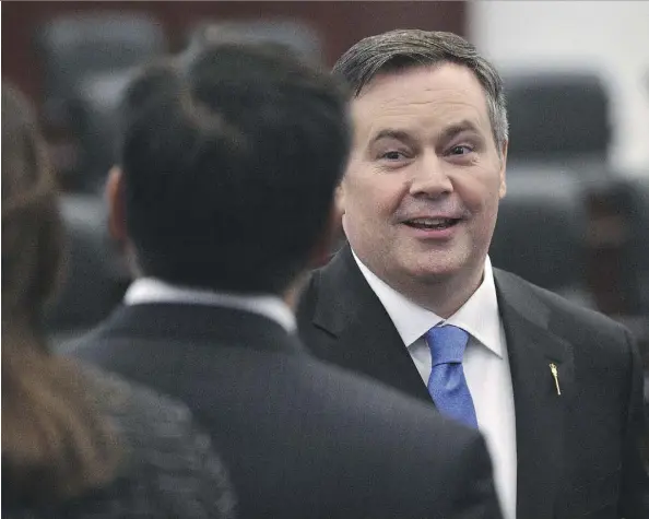  ?? ED KAISER ?? United Conservati­ve Party MLAs congratula­te Jason Kenney, who was sworn in Monday as member for Calgary-Lougheed at the Alberta legislatur­e. Kenney won a byelection in December, his fourth major win in the past several months, capturing over 70 per...