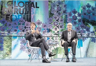  ?? CHRIS YOUNG THE CANADIAN PRESS ?? Prime Minister Justin Trudeau, left, talks with Fortune President Alan Murray at the Fortune Global Forum in Toronto on Monday.
