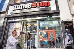  ?? JOHN MINCHILLO/AP FILE ?? The recent GameStop stock market frenzy provides what parents and educators call a teachable moment — an opportunit­y that presents itself to lend a little insight.