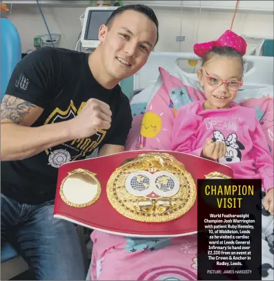  ??  ?? World Featherwei­ght Champion Josh Warrington with patient Ruby Hemsley, 10, of Middleton, Leeds as he visited a cardiac ward at Leeds General Infirmary to hand over £2,330 from an event at The Crown &amp; Anchor in Rodley, Leeds.
