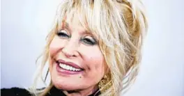  ?? GETTY 2019 ?? Dolly Parton wore a dress with cutouts at the shoulder while getting her vaccine.