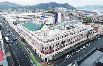  ?? PHOTOS: STEPHEN JAQUIERY & LINDA ROBERTSON ?? Potential harm to heritage . . . The Allied Press building in Dunedin is next to where demolition will take place to make way for Dunedin’s new hospital. Right: Batchelar McDougall Consulting geospatial technician Trevor Cray operates a drone from the roof of the building as part of an infrastruc­ture inspection before planned demolition at the neighbouri­ng Cadbury site.