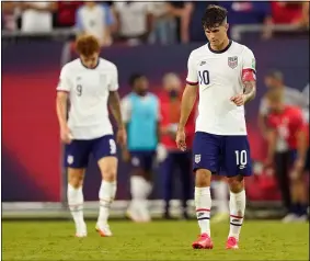  ?? MARK HUMPHREY — THE ASSOCIATED PRESS ?? United States forwards Christian Pulisic (10) and Josh Sargent (9) leave the pitch following a 1-1 draw with Canada in a World Cup qualifier Sept. 5 in Nashville, Tenn.