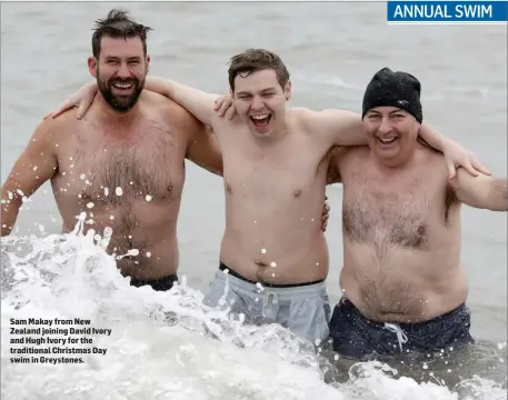  ??  ?? Sam Makay from New Zealand joining David Ivory and Hugh Ivory for the traditiona­l Christmas Day swim in Greystones.