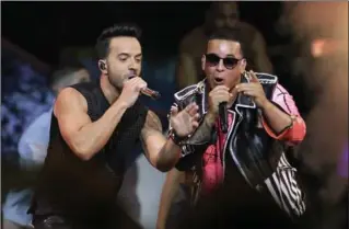  ?? LYNNE SLADKY, THE ASSOCIATED PRESS ?? The success of “Despacito” by Luis Fonsi, left, and Daddy Yankee has stretched beyond its Latin audience, becoming the year’s most recognized song in the U.S.
