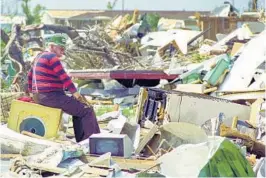  ?? STAFF FILE PHOTO ?? Sept. 7, 1992: Bill Edwards looks through debris of what was once his home at the DeSoto Trailer Park in Homestead.