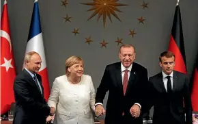  ?? AP ?? Leaders, from left, Russian President Vladimir Putin, German Chancellor Angela Merkel, Turkey’s President Recep Tayyip Erdogan and French President Emmanuel Macron pose at the end of a news conference following their summit on Syria, in Istanbul.