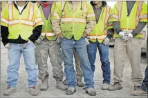  ??  ?? Workers with McCarthy Building Companies gather for a safety meeting.