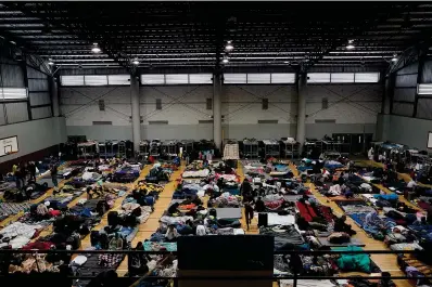  ?? The Associated Press ?? ■ Ukrainian refugees wait in a gymnasium on April 5, 2022, in Tijuana, Mexico. As many as 20,000 Ukrainians who were granted permission to remain in the United States for one year after fleeing the early fighting in their native country are facing their humanitari­an parole expiring, according to advocates.