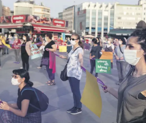  ??  ?? Women wearing protective face masks are seen during a demonstrat­ion to protest violence against women and child abuse during the coronaviru­s outbreak, Istanbul, Turkey, May 20, 2020.