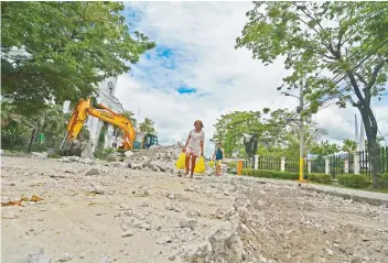  ?? SUNSTAR FILE ?? ROAD REPAIR. Cebu City’s public works department wants an additional budget to buy asphalt, whose price has increased since the Train Law was implemente­d.