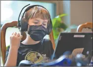  ?? (NWA Democrat-Gazette/Andy Shupe) ?? Chase McNair, 10, concentrat­es as he works to create a cartoon while completing school assignment­s at the family’s home south of Elkins.