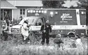  ?? WM. GLASHEEN/THE POST-CRESCENT ?? Emergency personnel search for an 11-year-old boy swept into a sewer after heavy rains Tuesday in Harrison, Wis.