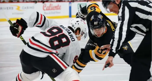  ?? BRUCE BENNETT/GETTY IMAGES ?? For Bedard (facing the Penguins’ Sidney Crosby in the opener), the ability to adapt to different linemates could end up defining his rookie season.