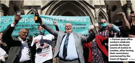  ?? Yui Mok ?? > Former post office workers celebrate outside the Royal Courts of Justice in London, after having their conviction­s overturned by the Court of Appeal