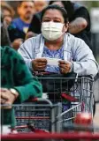  ?? Bob Owen / Staff photograph­er ?? Juana R. Mendez shops at a San Antonio-area H-E-B in March. Mendez said she has asthma and uses masks when shopping.