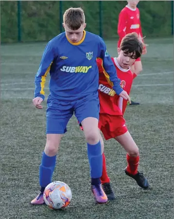  ??  ?? Wicklow’s Kieron Griffith holds off Cillian Geary of Midlands.