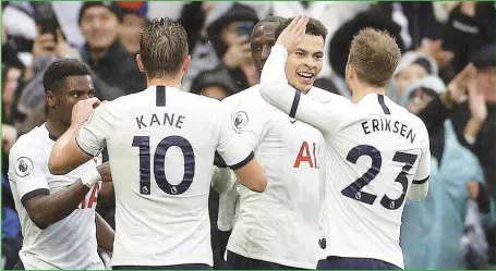  ??  ?? Dele Alli ( 2nd right) celebratin­g with teammates his winning goal against Brighton...yesterday afternoon