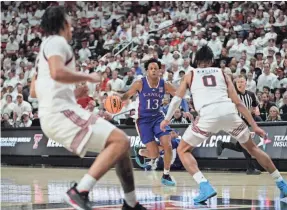  ?? MICHAEL C. JOHNSON/USA TODAY SPORTS ?? Kansas guard Elmarko Jackson (13) brings the ball up court against the Texas Tech defense.