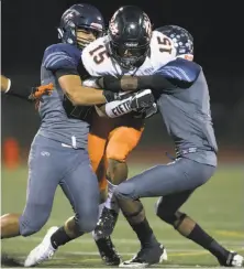  ?? D. Ross Cameron / Special to The Chronicle ?? Pittsburg’s A’jae Boyd (15) tries to split two Freedom-Oakley defenders in the second quarter.