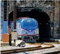  ?? KARL MERTON FERRON/BALTIMORE SUN ?? A northbound Amtrak train emerges from the Baltimore & Potomac Tunnel on its way to Baltimore’s Pennsylvan­ia Station.