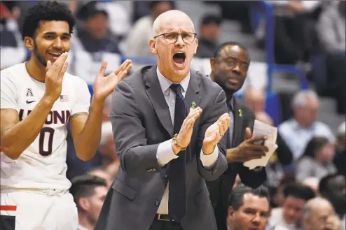  ?? Jessica Hill / Associated Press ?? UConn coach Dan Hurley cheers on his team during a February game against UCF in Hartford.