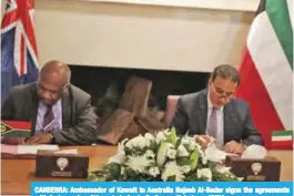  ??  ?? CANBERRA: Ambassador of Kuwait to Australia Najeeb Al-Bader signs the agreements with Ambassador of Vanuatu to Australia George Kaloris.