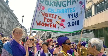  ?? AP ?? Women from Wokingham, join thousands of people marching through the streets to celebrate 100 years since women were granted the vote, in London.