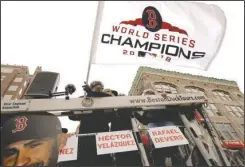  ?? The Associated Press ?? 2018 CHAMPIONS: Red Sox star J.D. Martinez waves the championsh­ip flag Wednesday during a parade in Boston to celebrate the team’s World Series victory over the Los Angeles Dodgers.