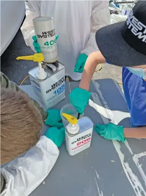  ??  ?? Bottom: The prep crew mixing a pot of 105/206 epoxy.