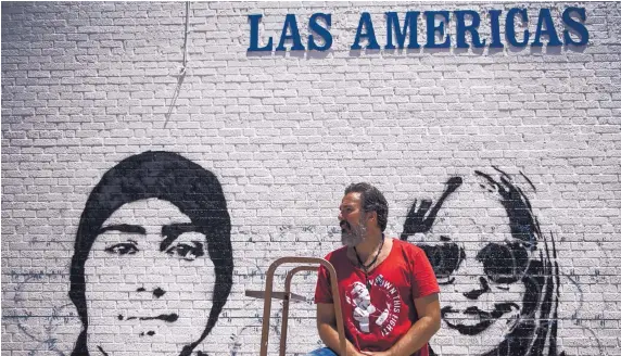  ?? ROBERTO E. ROSALES/JOURNAL ?? Sunday in El Paso, artist Manuel Oliver takes a break from painting a mural depicting his son, Joaquin Oliver, who was 17 when he was killed in a school shooting in Parkland, Florida, in 2018. Oliver happened to be in El Paso working on the mural when a mass shooting took place Saturday morning.