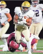  ?? ANDREW NELLES/THE TENNESSEAN ?? Christian Brothers’ Dallan Hayden (1) is tackled by MBA’S Ryan Schmadtke Friday night at Montgomery Bell Academy.