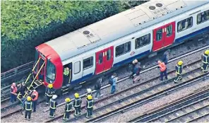  ??  ?? Passengers are helped from the train by emergency services, above. The streets around Parsons Green Tube station were sealed off, below left, by police, fire crews and anti-terrorism officers