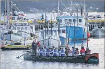  ?? TOM O’KEEFE/SPECIAL TO THE COMPASS ?? The crew of the Indianoak raise their oars in salute before leaving the Jerseyside harbour for their 10-day trip to St-pierre-miquelon.