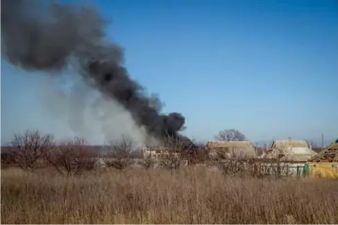  ?? L ?? A house burns after a Russian mi l itary strike near Vuh edar, Ukraine on Friday (Reuters)