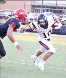  ??  ?? Senior Blackhawk Carson Rhine (No. 10) pushed away from a Hornet tackler during Friday night’s contest in Maumelle. Rhine racked up 72 yards on 13 attempts.