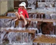  ?? GENE J. PUSKAR — THE ASSOCIATED PRESS ?? Cara Eshenbaugh, 4, of Pittsburgh, plays in a fountain on the Northside of Pittsburgh with the temperatur­e hitting 90degrees, Wednesday.