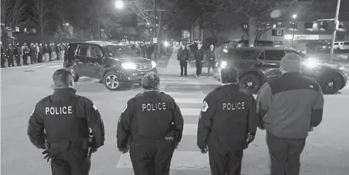  ?? JOHN J. KIM/CHICAGO TRIBUNE ?? Police officers stand in formation as a procession for a Chicago police officer reaches the building of the Cook County medical examiner’s office on March 5. A 38-year-old officer with 15 years of service apparently died by suicide earlier in the evening, according to police.