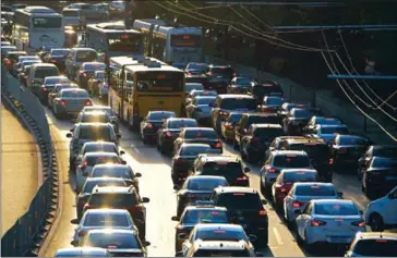  ?? GREG BAKER/AFP ?? A view of traffic in Beijing in April. China announced it will ban fossil fuel cars at an unspecifie­d date in a major boost to the production of electric vehicles as it seeks to ease pollution.