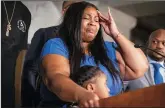  ?? LEILA NAVIDI/MINNEAPOLI­S STAR TRIBUNE ?? Roxie Washington, the mother of George Floyd’s 6year-old daughter Gianna Floyd, standing next to her, gets emotional during a press conference on Tuesday, at Minneapoli­s City Hall.