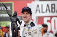  ?? BRYNN ANDERSON — THE ASSOCIATED PRESS ?? NASCAR driver Brad Keselowski holds up the trophy after the Alabama 500 at Talladega Superspeed­way, Sunday in Talladega, Ala.