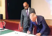  ?? CONTRIBUTE­D ?? Czeslaw Najmowicz (right), mayor of Ostróda in Poland, and Michael Belnavis, mayor of St Ann, signing an agreement to twin Ocho Rios with the Polish city. The ceremony took place in Ostróda yesterday.