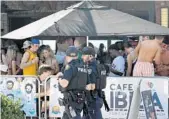  ??  ?? Police patrol the area in front of Cafe Ibiza in Fort Lauderdale on Thursday as Spring Break crowds swarm the beach.