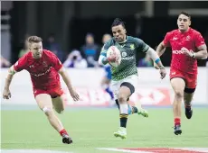  ?? DARRYL DYCK/THE CANADIAN PRESS ?? South Africa’s Rosko Specman, centre, outruns Canada’s Lucas Hammond, left, and Harry Jones on his way to scoring a try during World Rugby Sevens Series action at B.C. Place last March. Vancouver is hosting a World Rugby stop again this year.