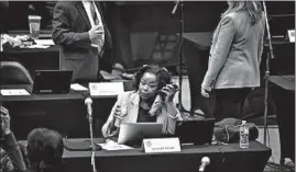  ?? E. JASONWAMBS­GANS/CHICAGO TRIBUNE ?? Rep. Sonya Harper, D-Chicago, works on the floor Friday at the Bank of Springfiel­d Center as the House of Representa­tives convenes for a lame-duck session.